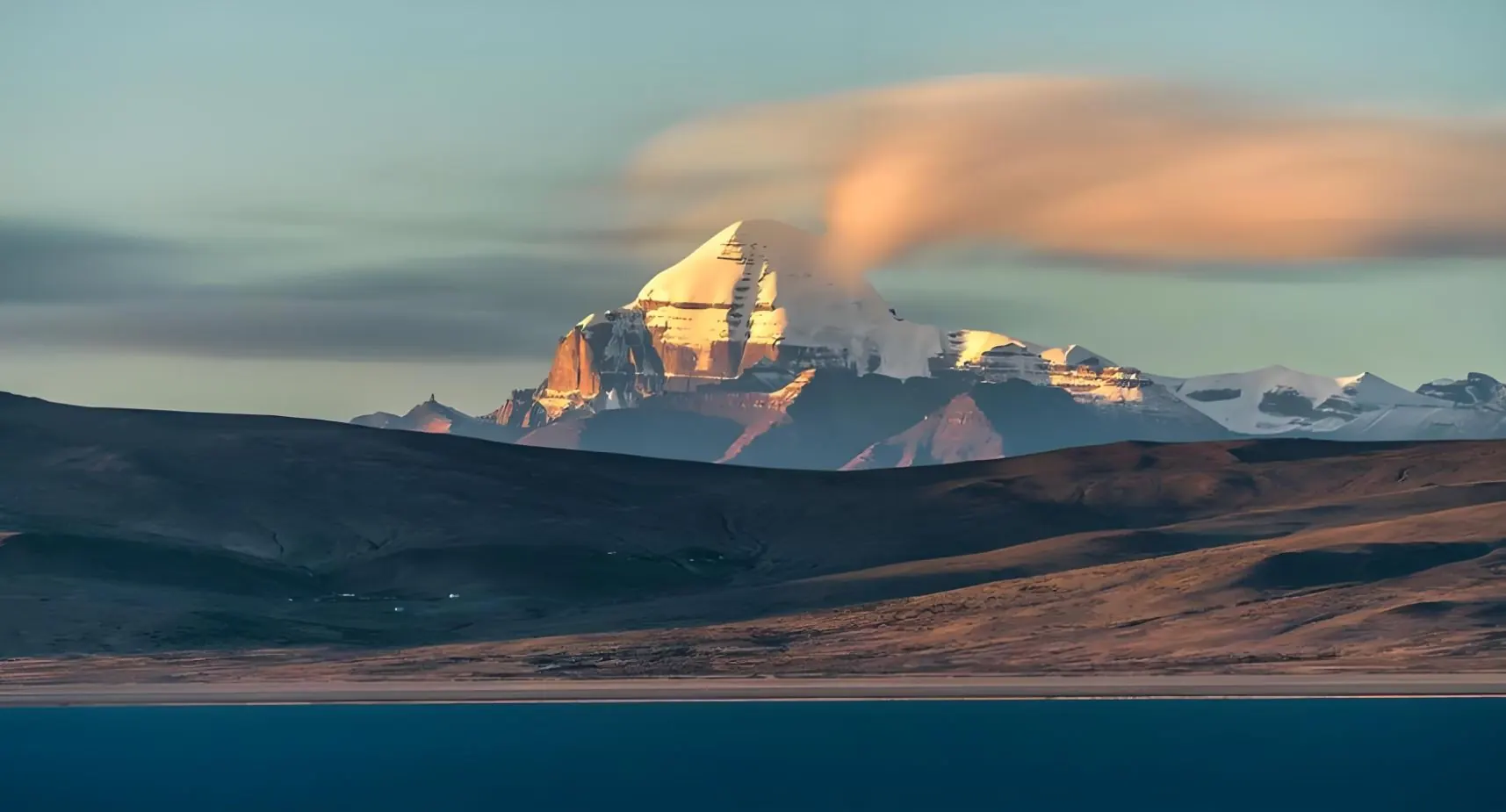 Mount Kailash at sunrise with Lake Manasarovar in the foreground